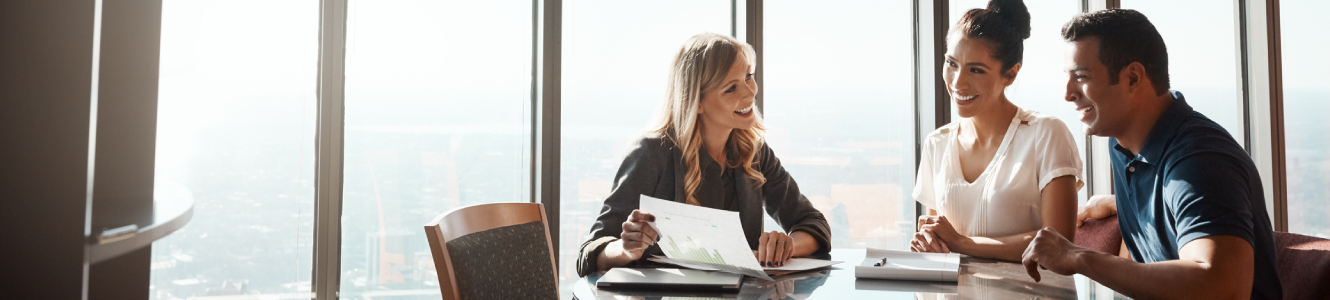 A woman meeting with young couple in office