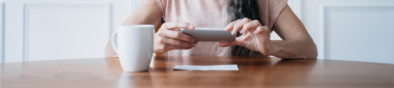 person using phone for remote deposit