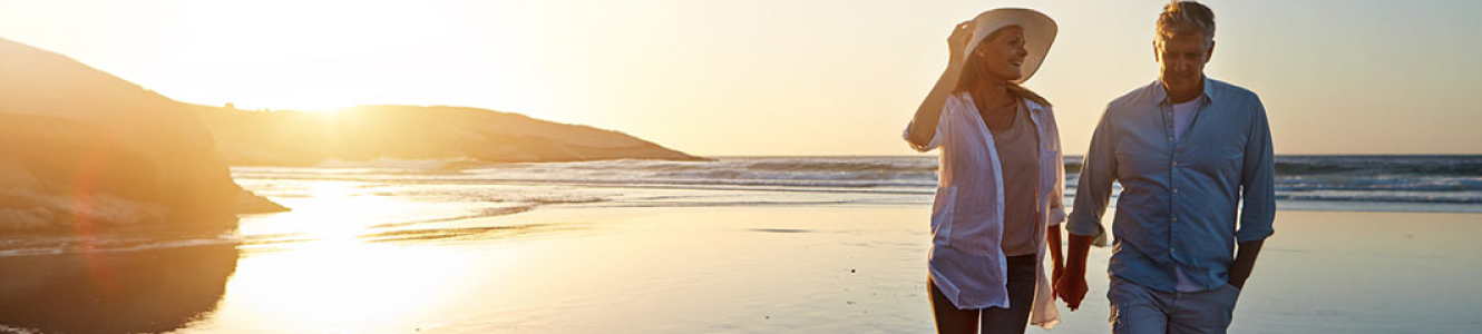 Mature couple walking on beach