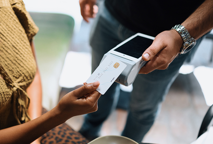 Person paying with debit card.