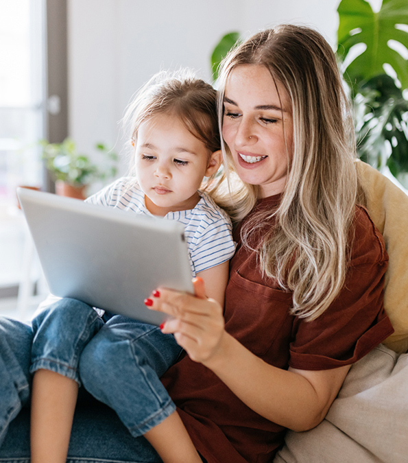 Mother and daughter looking at a tablet.