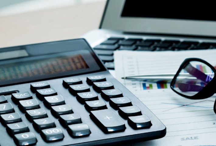 calculator next to a computer